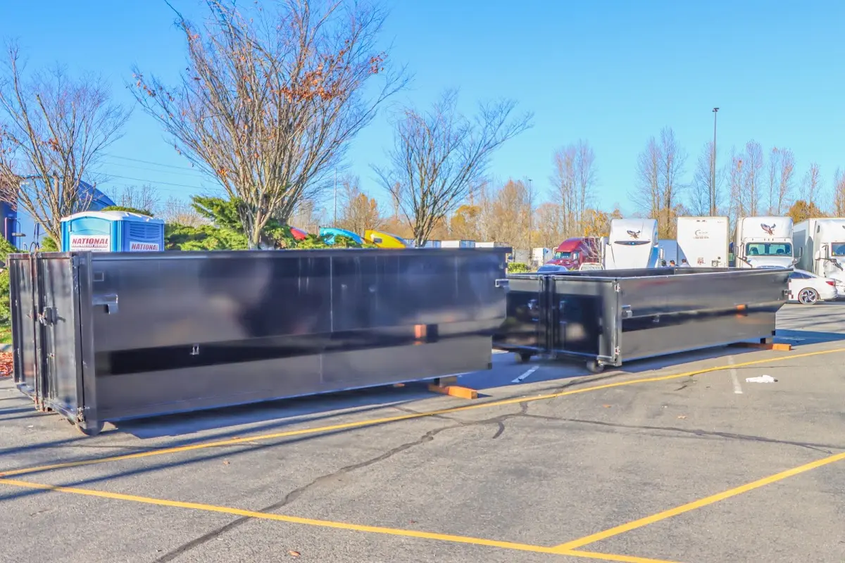 Professional dumpster rental service with roll-off container on residential driveway in Ionia